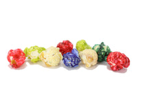 Load image into Gallery viewer, Colorful popcorn- with flavors such as sugar cookie, cherry, salted maple pecan on a white background
